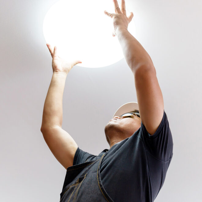 A man holding a plastic light covering