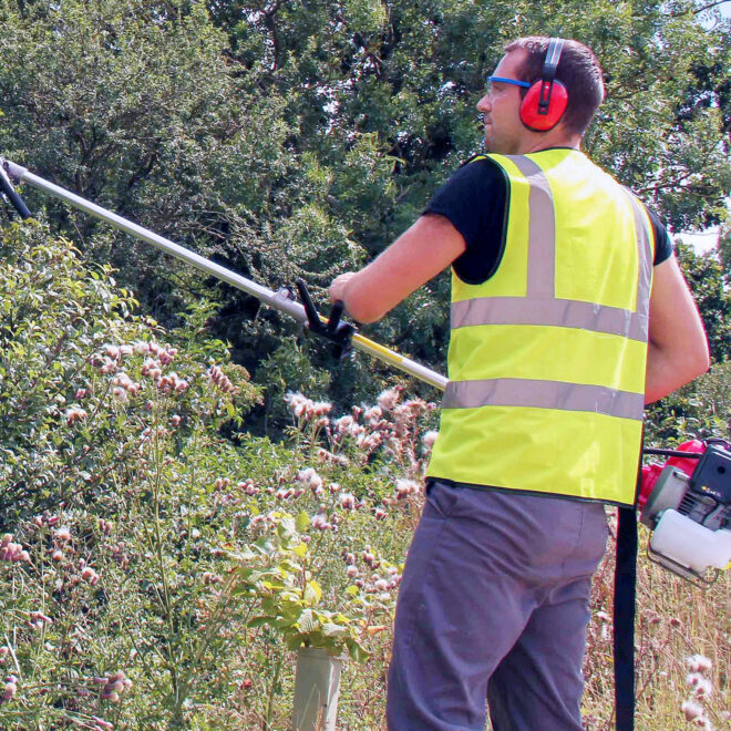 A man in high vis using a multi tool