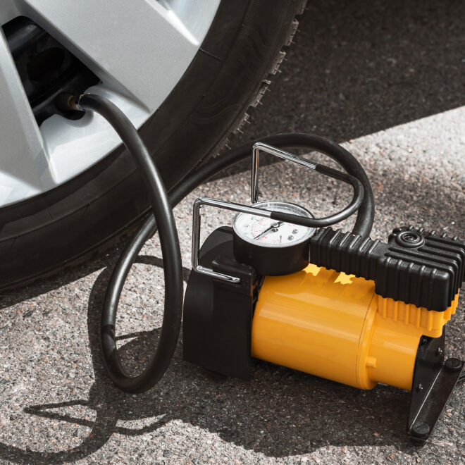 Air compressor plugged into a car wheel