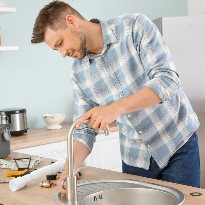 Man replacing kitchen sink