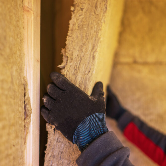 A man installing shed insulation